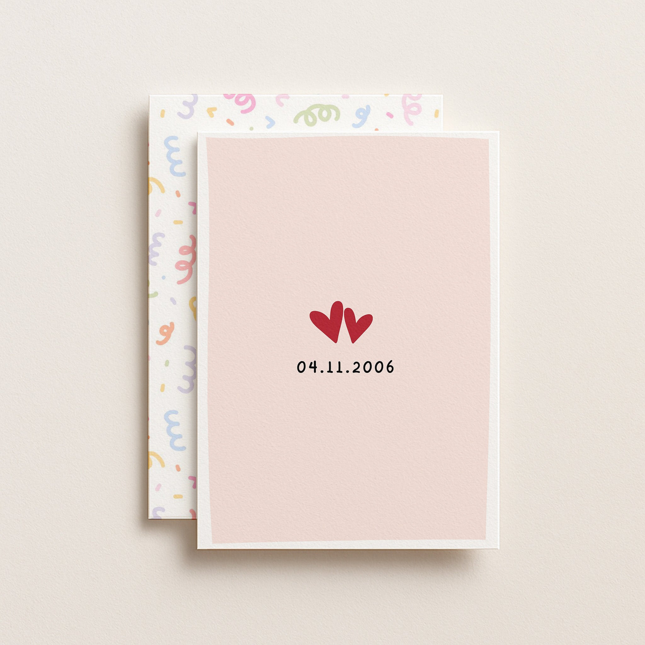 Front of anniversary love date greeting card with pastel envelope behind